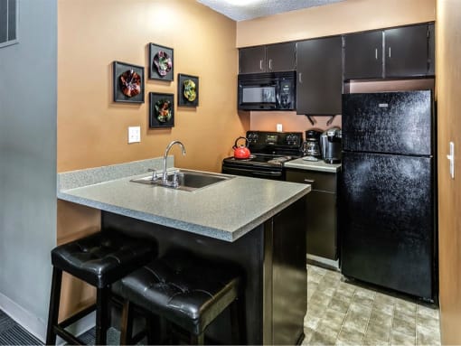 a kitchen with a sink and a refrigerator