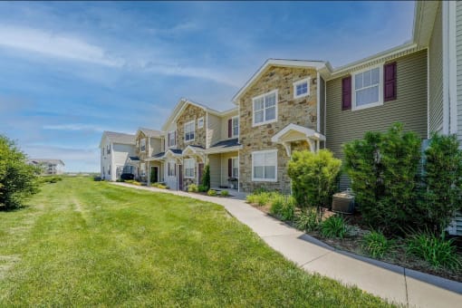 a row of houses on the side of a sidewalk