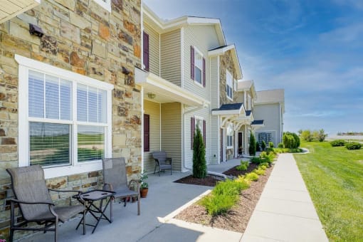 a row of apartment entrances with landscaping