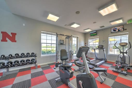 a gym with weights and a lot of windows