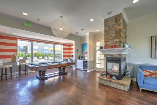 a game room with a pool table and a fireplace