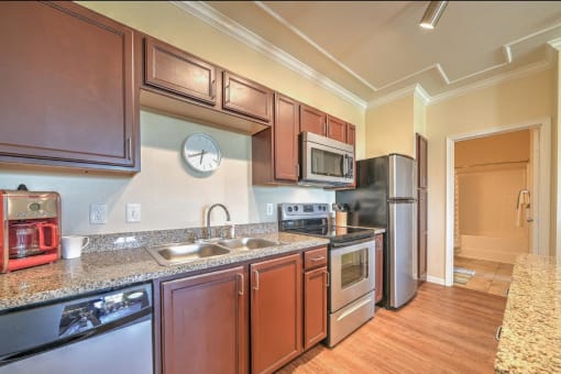 a kitchen with stainless steel appliances and granite counter tops