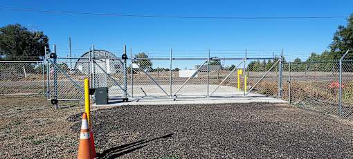 a gate into a fenced in area with a chain link fence