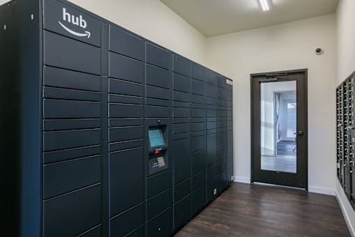 A row of Amazon hub storage units are lined up in a hallway.