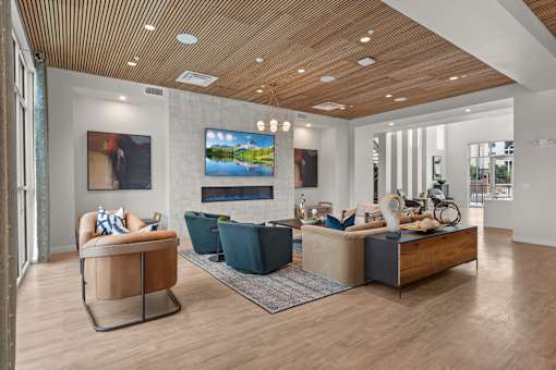A modern living room with a wooden ceiling and a large painting on the wall.