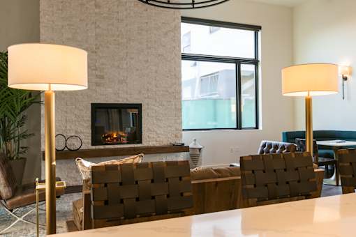 A living room with a fireplace and two lamps.