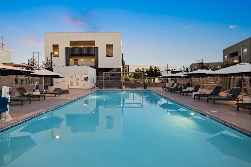 A large swimming pool in front of a modern building.