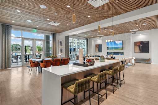 A modern kitchen with a bar area and a view of the outdoors.