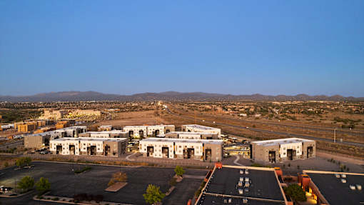 A large building complex with a parking lot in front.