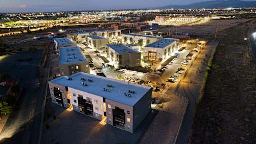 A large industrial building complex is lit up at night.