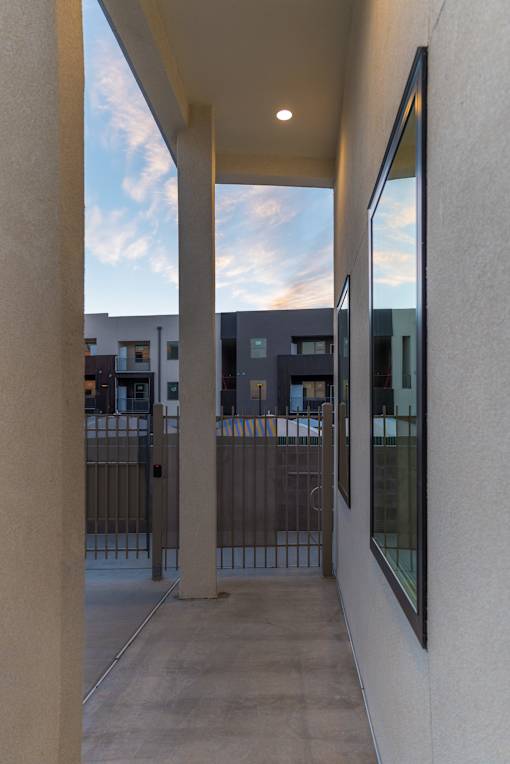A long hallway with a view of the sky through the windows.