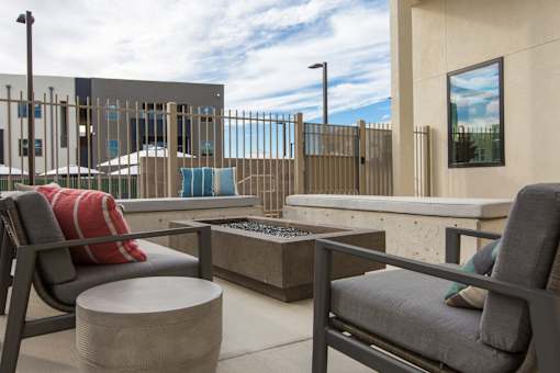 A patio with two chairs and a table.