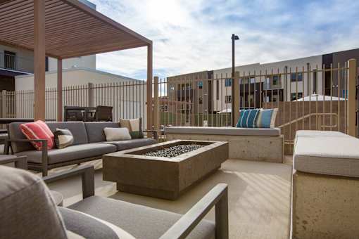 A patio with a couch, table, and chairs.
