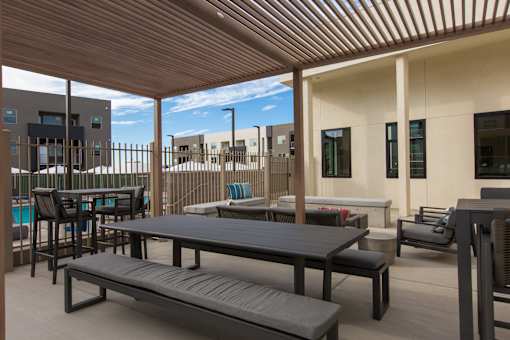 A patio with a table and chairs.