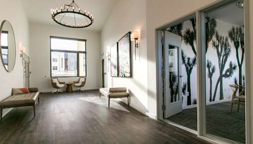 A room with a large window and a view of trees outside.