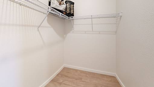 A white wire shelf with a few items on it.