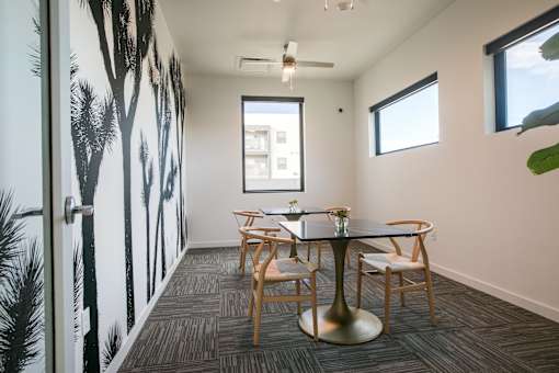 A dining room with a table and chairs.