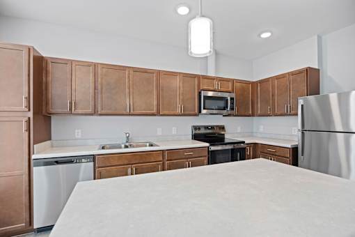 A kitchen with brown cabinets and a white refrigerator.