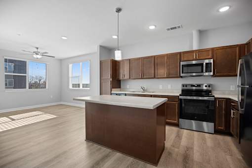 A modern kitchen with wooden cabinets and stainless steel appliances.