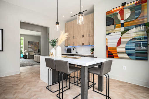 A modern kitchen with a dining table and chairs.