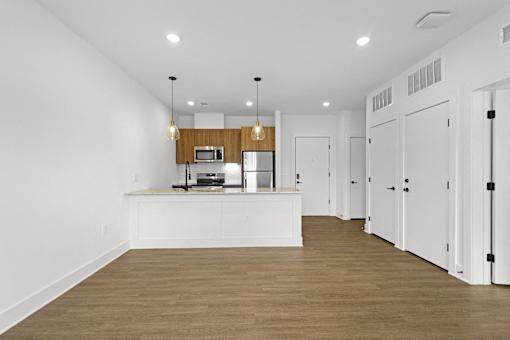 A kitchen with white cabinets and a wooden island.