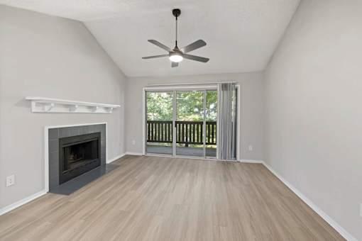 A room with a fireplace and sliding glass doors.