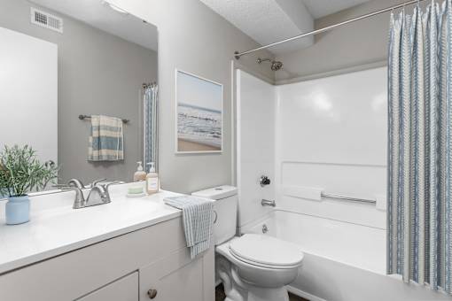 A bathroom with a white toilet and a white sink.