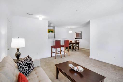 A living room with a couch, chairs, and a coffee table.