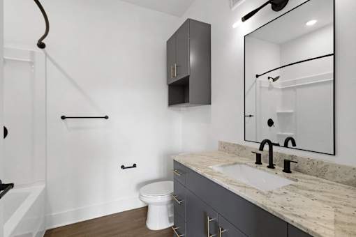 A white toilet sits next to a sink in a bathroom.