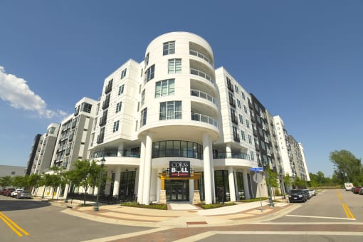a large white building on the corner of a city street
