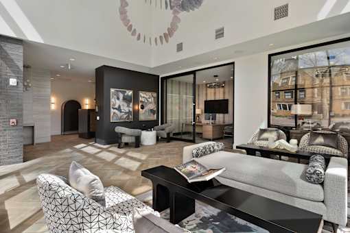 A modern living room with a grey sofa and a black coffee table.