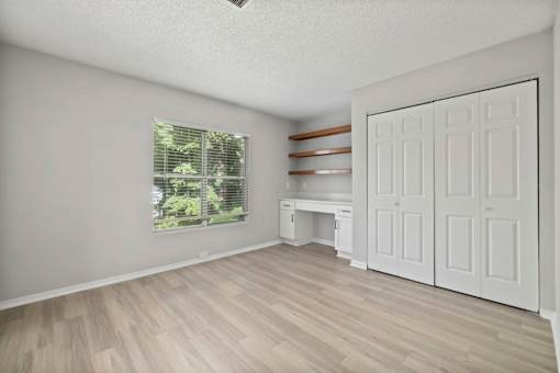 A room with a window and a white door.