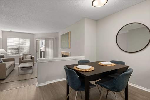 A dining room with a table set for two.