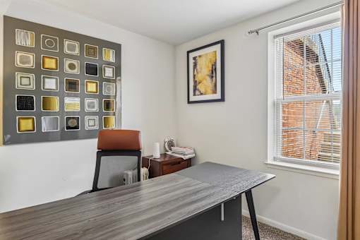A room with a grey table and a brown chair.