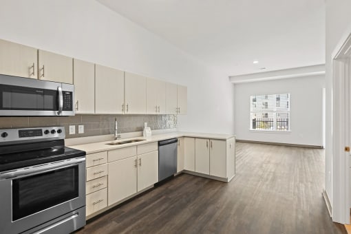 a kitchen with white cabinets and stainless steel appliancesat Metropolis Apartments, Glen Allen