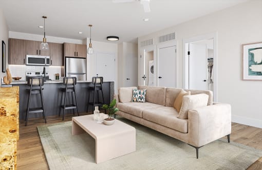 a living room and kitchen with a couch and a coffee table at Boardwalk at Research Park in Huntsville, AL