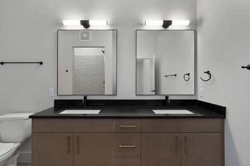 A bathroom with two sinks and a toilet.