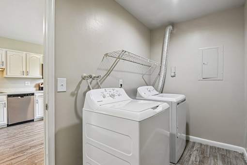 A white dryer and washer in a laundry room.
