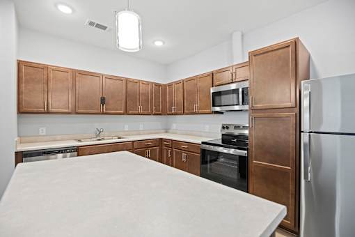 A kitchen with brown cabinets and a white countertop.