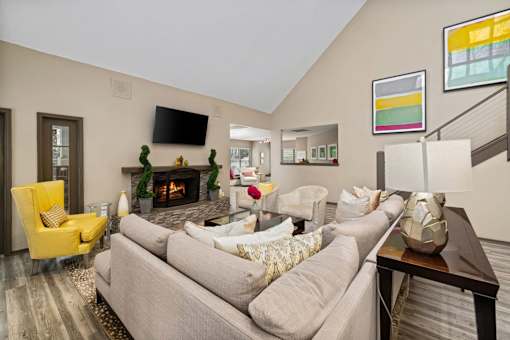 A living room with a grey couch and a yellow chair.