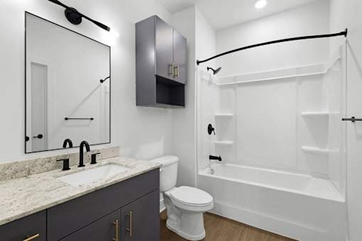 A white toilet sits next to a sink in a bathroom.