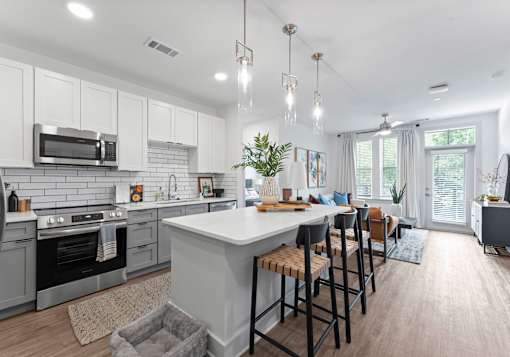A modern kitchen with a large island and bar stools.