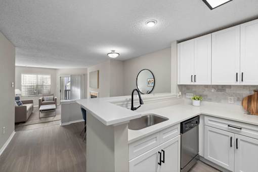 A modern kitchen with white cabinets and a large island.