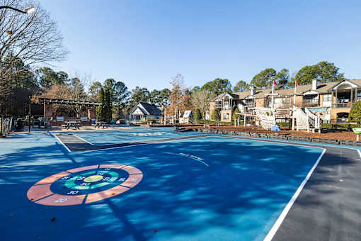 A blue painted court with a red and blue target in the middle.