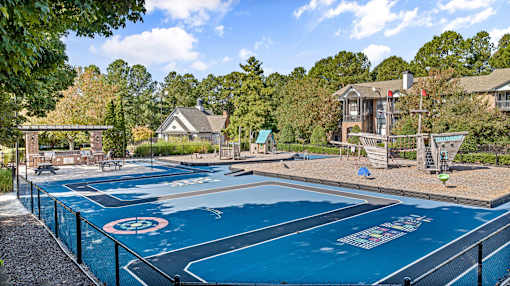 A blue painted basketball court with a white circle and a white line in the middle.