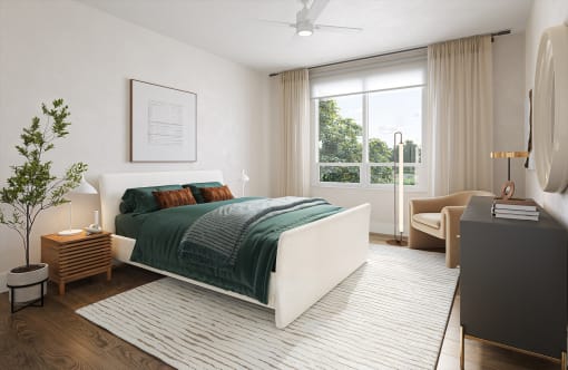 a bedroom with a white bed and a green blanket at Boardwalk at Research Park in AL 35811