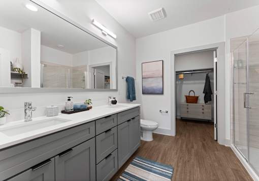 A bathroom with a white sink and a toilet.