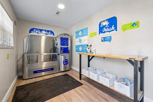 A clean and organized laundry room with a washing machine and a dryer.