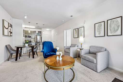 A living room with a blue chair and grey armchair.
