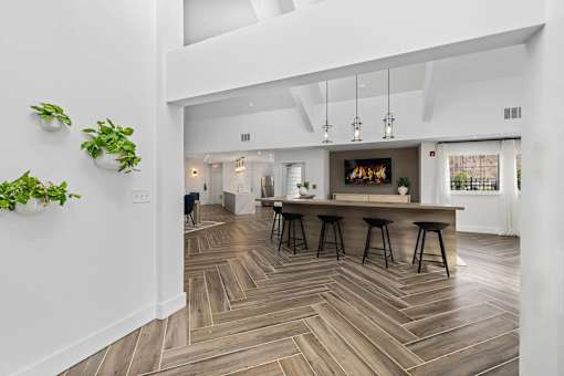 A modern kitchen with a bar area and a fireplace.